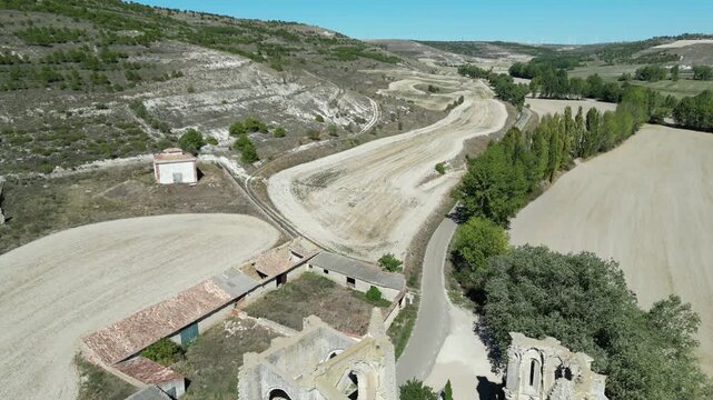 A drone shot of San Anton ruins beside winding rural roads on Camino de Santiago in Spain