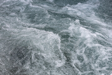 Fototapeta premium Turmoil of churning water, frothy and swirling