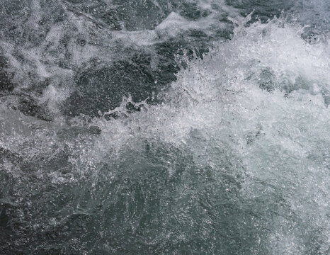 Churning water creates white, frothy waves