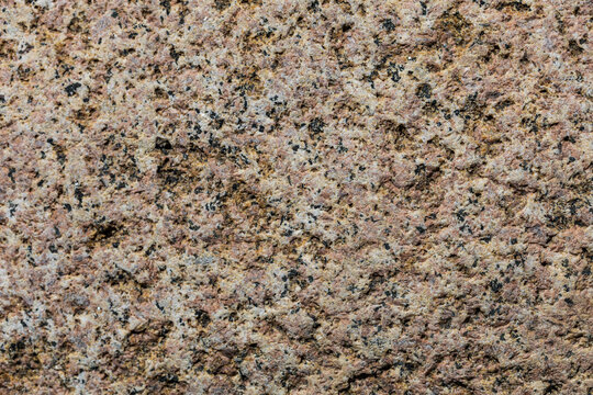 Granite surface with speckled brown and gray mineral patterns