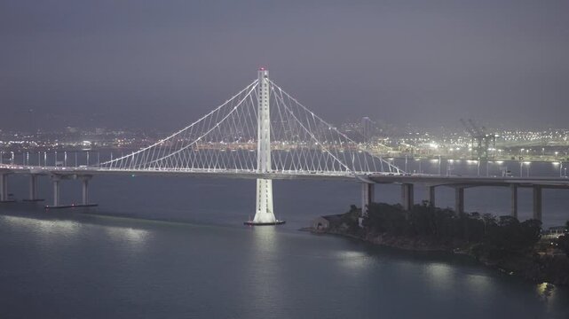 Glowing Cable-Stayed San Francisco Bay Bridge With Stormy Mist - Aerial Shot