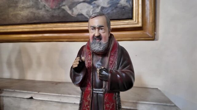 Small statue of Saint Padre Pio on a devotional altar