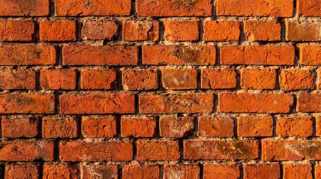 Weathered red brick wall texture background with rustic industrial character