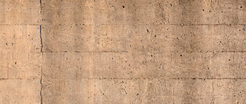 Board formed concrete wall texture background with warm wood grain imprint