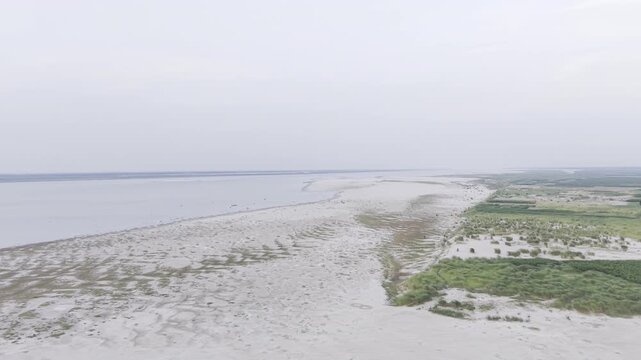 A wide aerial drone view of the Gorai Confluence in Kushtia, Bangladesh, revealing expansive sandbars, river channels, and lush vegetation from above in crisp 4K resolution.