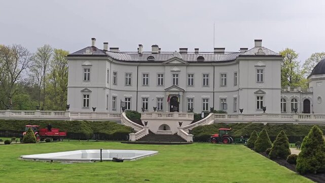 Palanga Amber Museum is located in the Palanga Botanical Garden, Lithuania. The image features the neoclassical Tiskeviciai Palace, housing the museum. Its grand facade displays symmetry