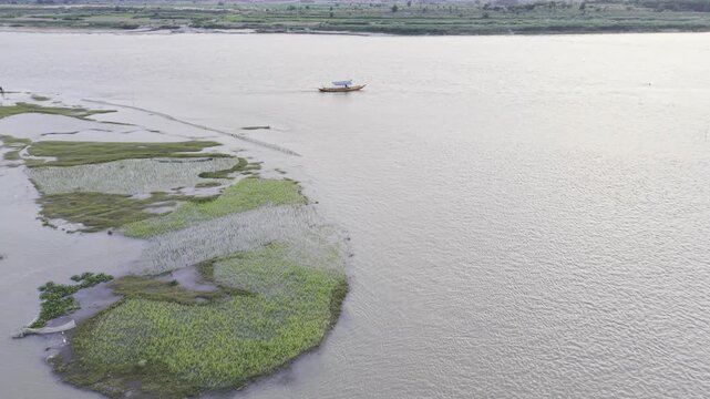 Aerial Follow Shot of a Boat on the Padma River in Bangladesh