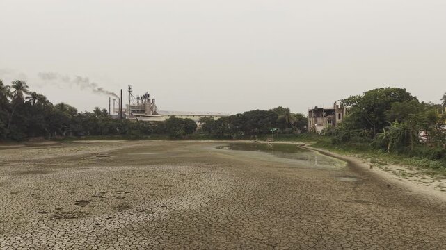 Industrial Factory Overlooking a Dried Pond During Severe Drought in Bangladesh