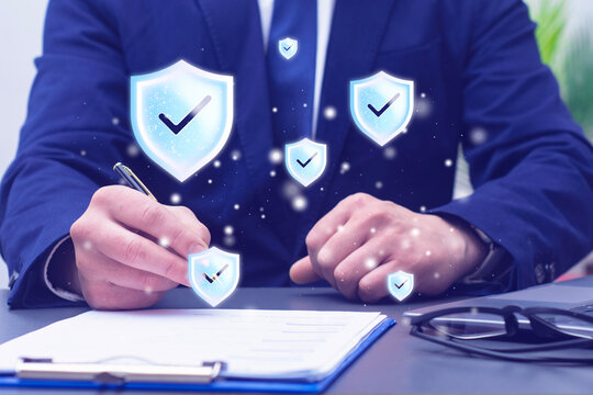 Businessman signing a contract with digital shield icons representing security and compliance. Legal agreement, insurance policy, data protection, risk management, corporate governance and business.
