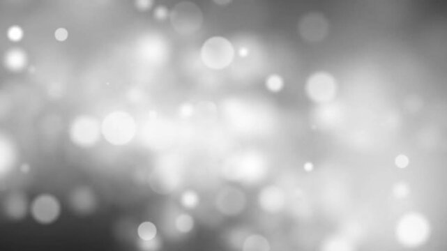 A dreamy soft-focus image featuring white bokeh lights against a gray background. This abstract composition is perfect for adding an ethereal touch to your designs.