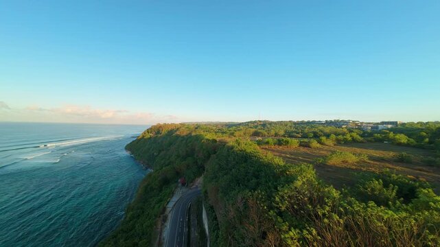 Smooth Cinematic Aerial Flight Above Deep Cliff Passage At Pantai Tanah Barak, Sunrise Light Illuminating Green Fields And Coastal Terrain, Progress And Discovery
