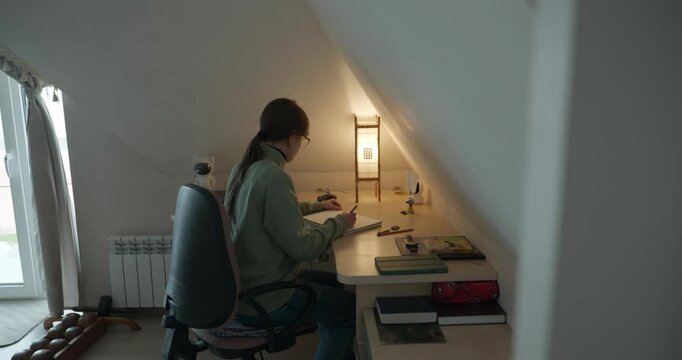 Girl Draw Pictures With Pencil on Desk Table in Bedroom at Home. 4K 10-bit
