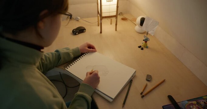 Girl Draw Pictures With Pencil on Desk Table in Bedroom at Home. 4K 10-bit