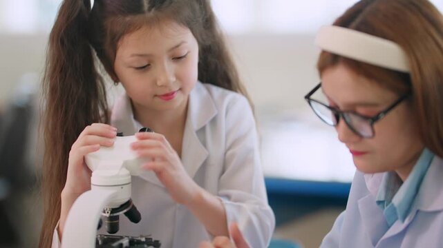 Girl peers through microscope with curiosity and focus. Scientist guides her, offering gentle support and advice. Young minds explore science with wonder and teamwork. Ideal for education, learning
