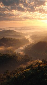 Misty valley landscape at sunrise with rolling hills and cloudy sky