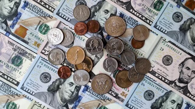 Paper US dollar bills of various denominations and cent coins as a business tool for exchange and trade. Cash US dollars as a background for your design