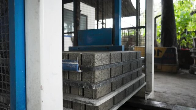 Machine Placing Concrete Blocks on Production Line