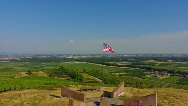 American flag waving over Alsace valley landscape monument viewpoint travel destination