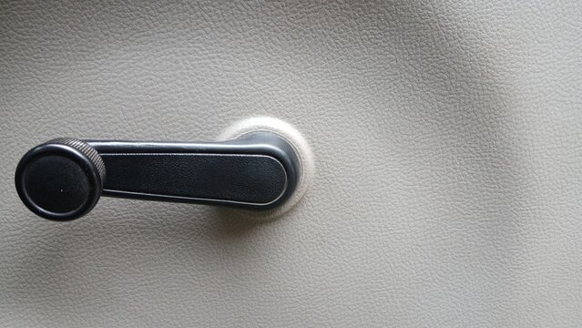 Close-up photo of the manual window crank in a truck.