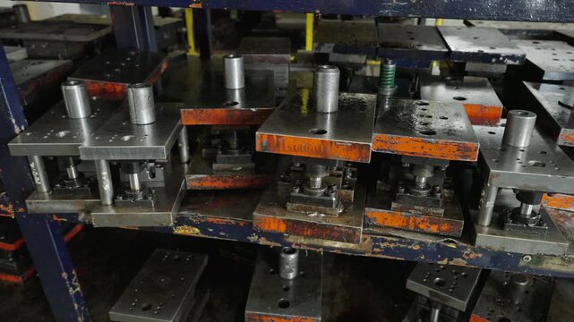 Close-Up of Stamping Dies and Molds on Factory Storage Shelf