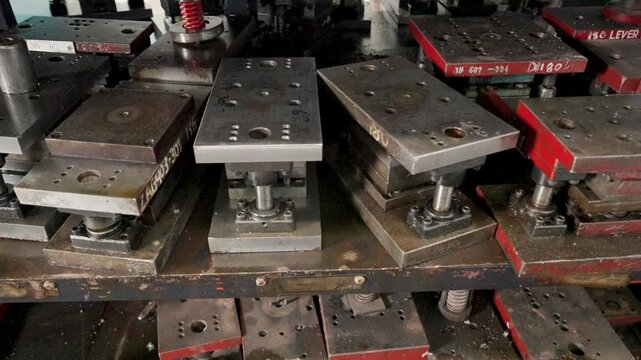 Close-Up View of Industrial Molds Stacked on Storage Shelf