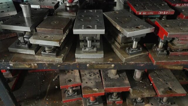 Steel Molds and Machine Parts Stored on Factory Rack Shelf