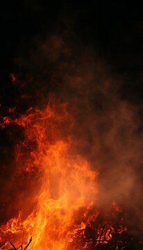 Intense Fire Flames Glowing In Darkness Creating An Atmospheric Smoke filled Halloween Background