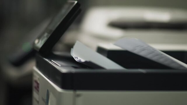 Photocopier Machine Printing Paper in Modern Office Close Up