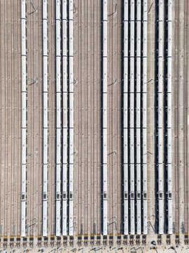 Aerial view of the Old Oak Common Elizabeth Line Depot with multiple white trains parked on parallel tracks in London, England, United Kingdom.