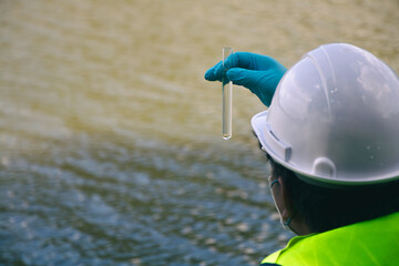 Field technicians performing water sample collection for environmental testing and conservation. © r_tee