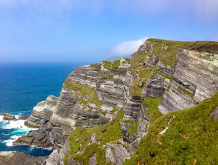 Dramatic rugged cliffs of the Irish coast dropping into the Atlantic Ocean on a sunny day © Elizabeth