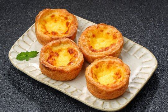egg tart with a flaky, buttery pastry crust and smooth, creamy custard filling. A popular bakery dessert inspired by Portuguese and Hong Kong styles