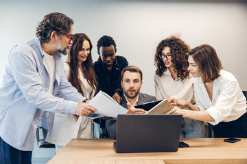Fototapeta premium Diverse business team collaborating and discussing documents in office