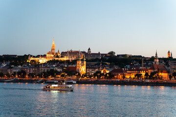 Fototapeta premium Illuminated Matthias Church and Buda skyline at blue hour twilight