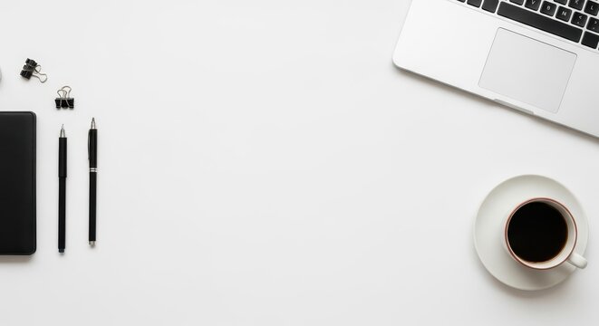 A minimalist modern white workspace featuring a clean laptop on a desk, ideal for productivity and remote work setups.