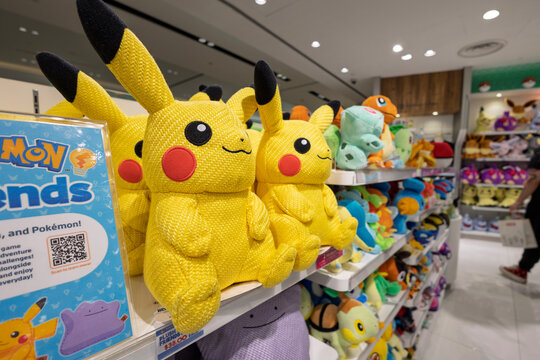 Singapore - January 21, 2026: A close-up view of unique textured knit fabric Pikachu plush toys on a retail display shelf inside an official Pok&eacute;mon Center store.