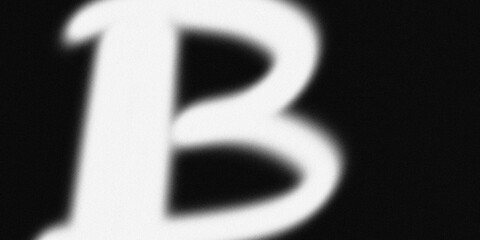 Blurred white letter b with spray painted edges on black surface displaying grainy film noise and distorted typography elements. © yousuf757