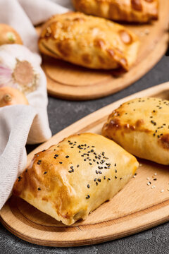 Chicken samsa pastries with glossy browned crust, black sesame and onions for restaurant menu