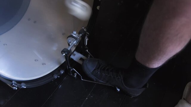 Foot tapping on bass drum in music practice session at home studio