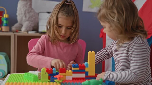 Girl arranging colorful plastic blocks with hands at a play table in a building; quiet concentration.