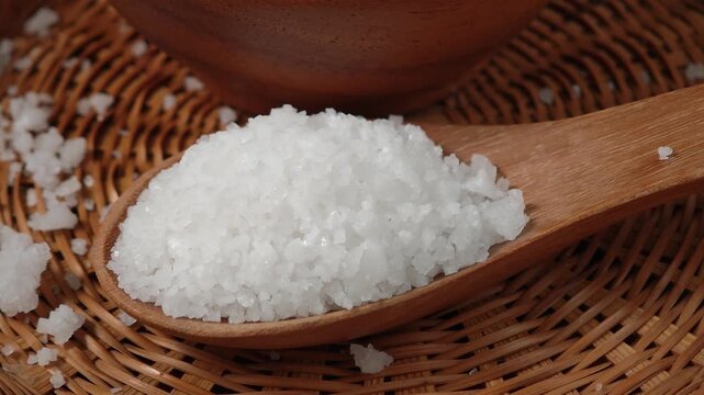 Close-up of Coarse Sea Salt Crystals on a Wooden Spoon

