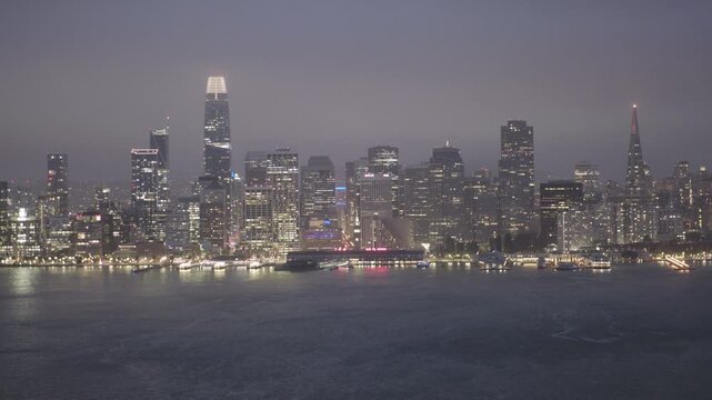 Sparkling San Francisco Downtown Skyline From Bay at Night Overcast Sky - Wide, Drone Shot