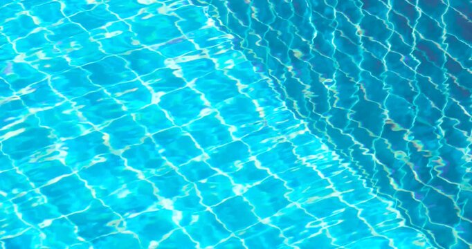 swimming pool water with shimmering sunlight reflections and blue ripples, crystal clear swimming pool water, refreshing, relaxing summer atmosphere, ideal for travel, resort, luxury background
