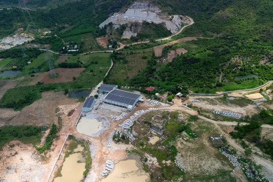 Aerial view shows a stone processing facility with solar panels on its roofs
