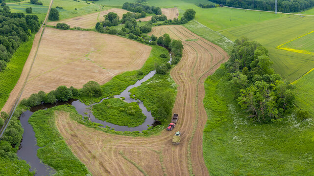 Aerial View of River Bend and Farmland with Tractor