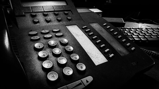 Old black office telephone keypad in monochrome