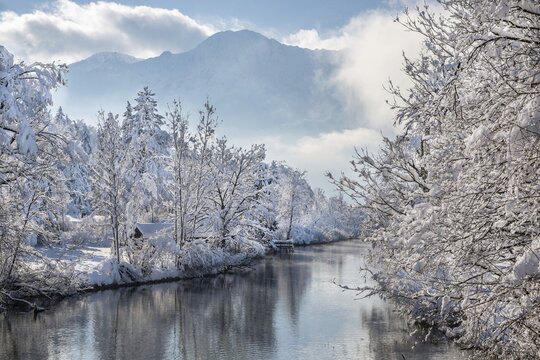 Winter landscape with outflow of the Loisach from the Lake Kochel in front of the Herzogstand 1731m, Kochel am See, Das Blaue Land, Bavarian Alps, Upper Bavaria. Bavaria, Germany