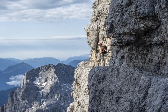 Climbers on a rock band, Bocchette Centrale band trail, via ferrata in the Brenta Mountains, Brenta-Adamello Natural Park, Trentino, Italy