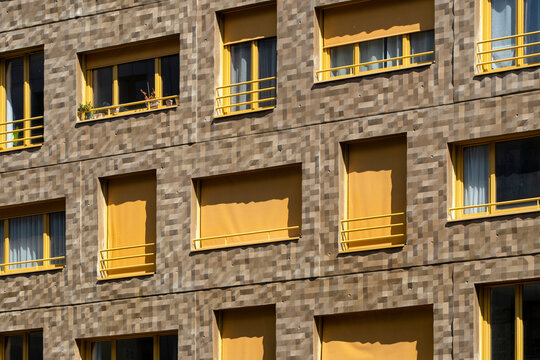 New apartments architecture documents residential development in La Confluence, Lyon, France, where an urban building facade brings yellow rhythm to the district