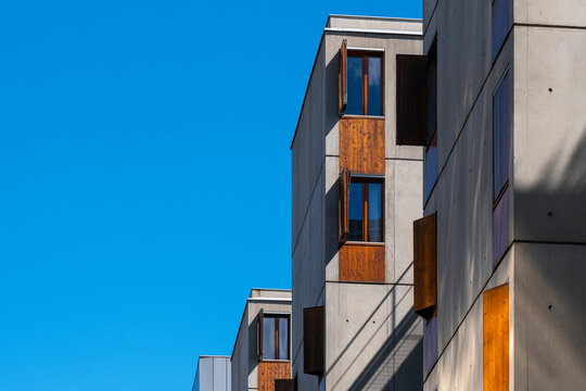 New apartments architecture in La Confluence, Lyon, France records residential development as an urban building edge turns within the district under clear sky